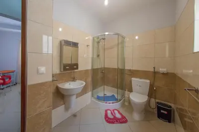 a bathroom with a shower and a toilet and a sink at Laginha Beach Guest House in Mindelo