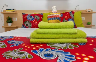 a bed with a pile of green towels on it at Aparthotel Ca Bonita in Sal Rei