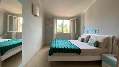 a bedroom with two beds and a window at Sal Apartments Djadsal Moradias in Santa Maria