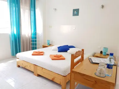a bedroom with a bed and a table with towels on it at Casa D'Mar in Ponta do Sol