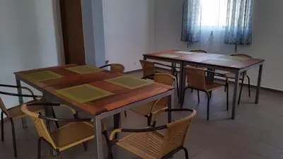 a group of tables and chairs in a room at Casa Patio in Tarrafal