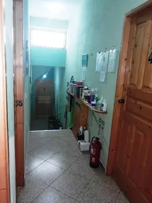 a room with a kitchen with green walls and a door at Pousada Villa Concetta AC in Cidade Velha