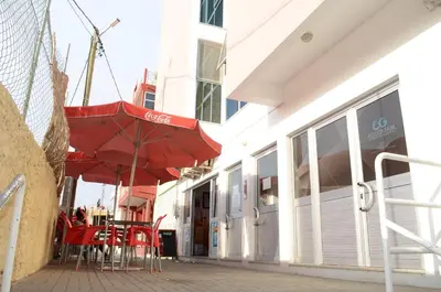 a red umbrella sitting outside of a building at Apartamento Rita in Praia