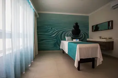a bedroom with a bed with a painting on the wall at Tiduca Hotel in Ponta do Sol