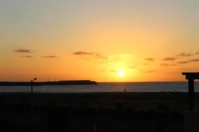 a sunset on the beach with the sun setting at PORT DO SOL-free wi-fi no limits in Sal Rei