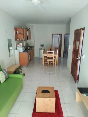a living room with a green couch and a table at IMOBITUR-Tourist Apartments- Palmarejo Centro AV SV in Praia