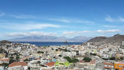 a city with buildings and the ocean in the background at Bouganville in Mindelo