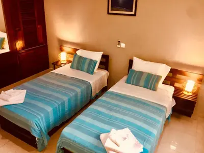 two beds in a hotel room with towels on them at Casa Santa Barbara Deluxe in Ribeira Grande