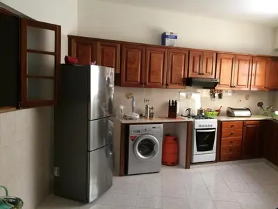 a kitchen with a refrigerator and a washing machine at Vannilla Residencial in Mindelo