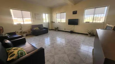 a living room with two couches and a flat screen tv at Meeting Point Hostels-Praia Beachwalk-NO CASH ACCEPTED-Also in Fogo & Tarrafal in Praia