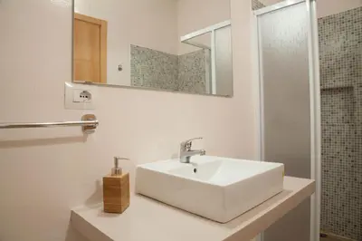 a bathroom with a white sink and a mirror at Ca Marta Penthouse in Sal Rei