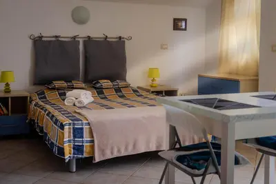 a bedroom with a bed with a stuffed animal on it at Santa Maria flats in Santa Maria