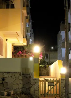 a building with lights on the side of it at night at Santa Maria flats in Santa Maria