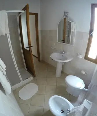 a bathroom with a sink and a toilet and a shower at Ca' Greta - Big apartment close Estoril beach in Sal Rei