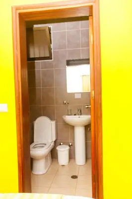 a bathroom with a toilet and a sink at Pousada Quinta Ribeirinha in Cidade Velha