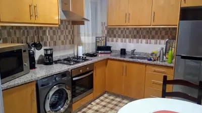 a kitchen with a stove and a washer and sink at Private Apartament Celestina & Carlos in Mindelo