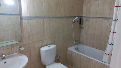a bathroom with a toilet and a sink and a tub at Hotel Savana in São Filipe