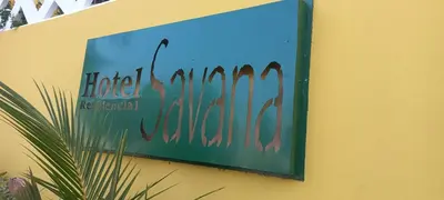 a sign on the side of a building at Hotel Savana in São Filipe