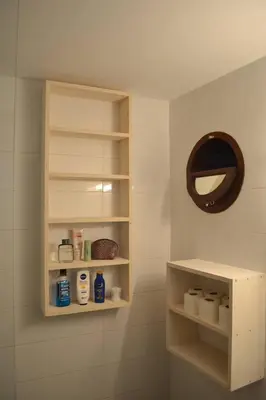 a bathroom with white shelves and a mirror at Studio M in Mindelo