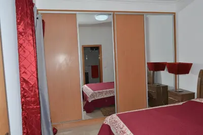 a bedroom with a mirror and a bed in it at House Gonçalves in Praia