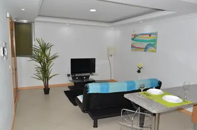 a living room with a couch and a table at Apartamento Augusto in Praia