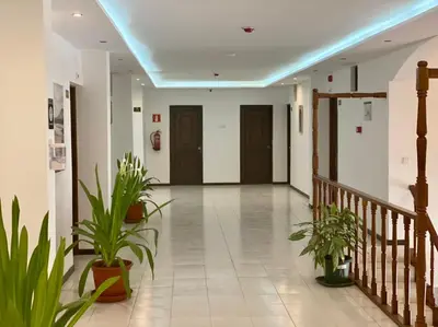 a hallway with potted plants in a building at ApartHotel NhaTerra in Santa Maria