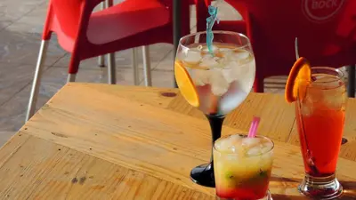 two cocktails sitting on a wooden table at Mix 2 in Mindelo
