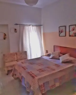 a bedroom with a bed and a couch and a window at Mix 2 in Mindelo