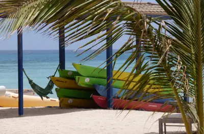 a stack of colorful surfboards on the beach at EMPFEHLUNG der MEERJUNGFRAU in Sal Rei