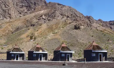 a group of huts in front of a mountain at Casa Marisa 2.0 in Portela