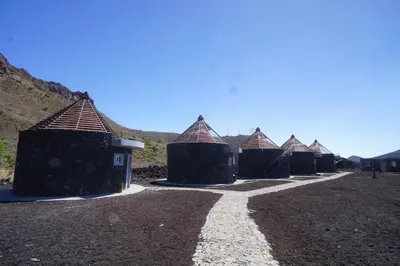 a row of houses with roofs on a dirt field at Casa Marisa 2.0 in Portela