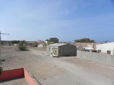 a dirt road in a small town with buildings at A Caminhada in Morro