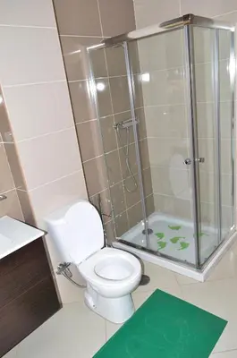 a bathroom with a toilet and a glass shower at Apartamento Justino in Praia