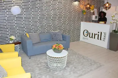 a living room with a blue couch and a table at Ouril Hotel Agueda in Sal Rei