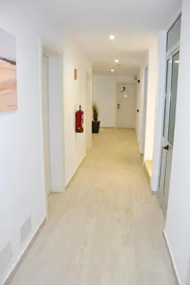 an empty hallway of an office with a fire extinguisher at Ouril Hotel Agueda in Sal Rei
