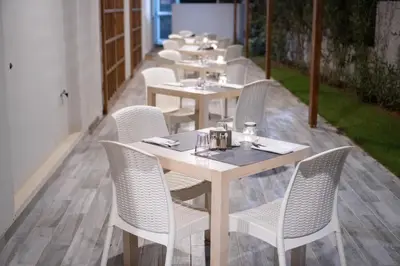 a row of tables and chairs in a restaurant at Sobrado Boutique Hotel in Santa Maria