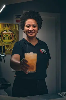 a woman holding a drink in her hand at Sobrado Boutique Hotel in Santa Maria