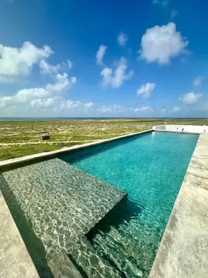 a swimming pool with a view of the ocean at Spinguera Ecolodge in Espingueira