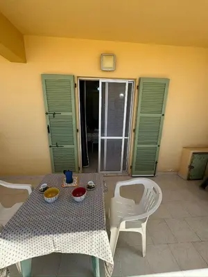 a table with two chairs and a table with food on it at Vista Do Mar Studio Praia Cabral in Sal Rei