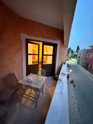 a patio with a table and chairs and a window at Apartament Orange B12 Estoril free wi-fi Sal Rei in Sal Rei