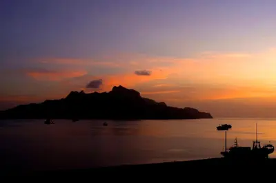 a sunset over a small island in the water at Hotel LIVVO Don Paco in Mindelo