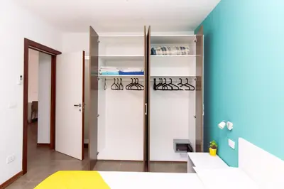 a bedroom with white and blue walls at Apartamento Las Rochas in Mindelo