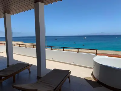 a bathroom with a tub and a view of the ocean at Hotel Casa Evora - luxury and beach front in Vila do Maio