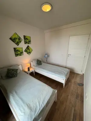 a bedroom with two beds and a lamp in it at CA MINHA Praia Estoril Sal Rei Boa Vista in Sal Rei