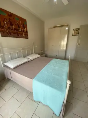 a bedroom with a bed with a blue blanket on it at Sea view Ka Paola, Praia Cabral, Boa Vista, FREE WI-FI in Sal Rei