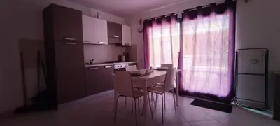 a kitchen with a table and chairs and a window at Sal Service beachside angulo in Santa Maria