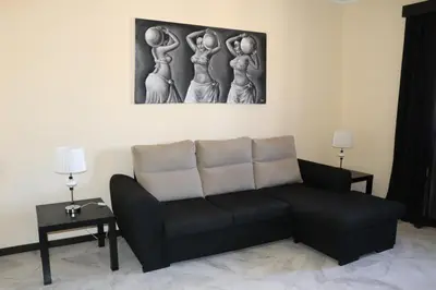 a living room with a couch and a painting on the wall at Apartamento Preguiça in Espargos