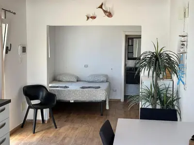 a living room with a bed and a chair at Casa Tud Dret - By Bobbywashere in Sal Rei