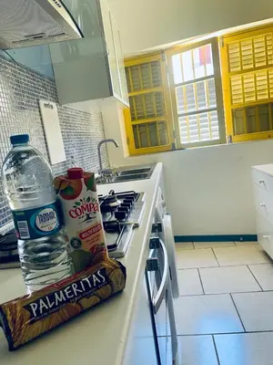 a kitchen with a bottle of water and a bag of peanuts at La Residencia in Mindelo