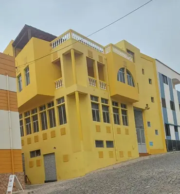 a yellow building on the side of a street at Casa Amarela in Ponta do Sol